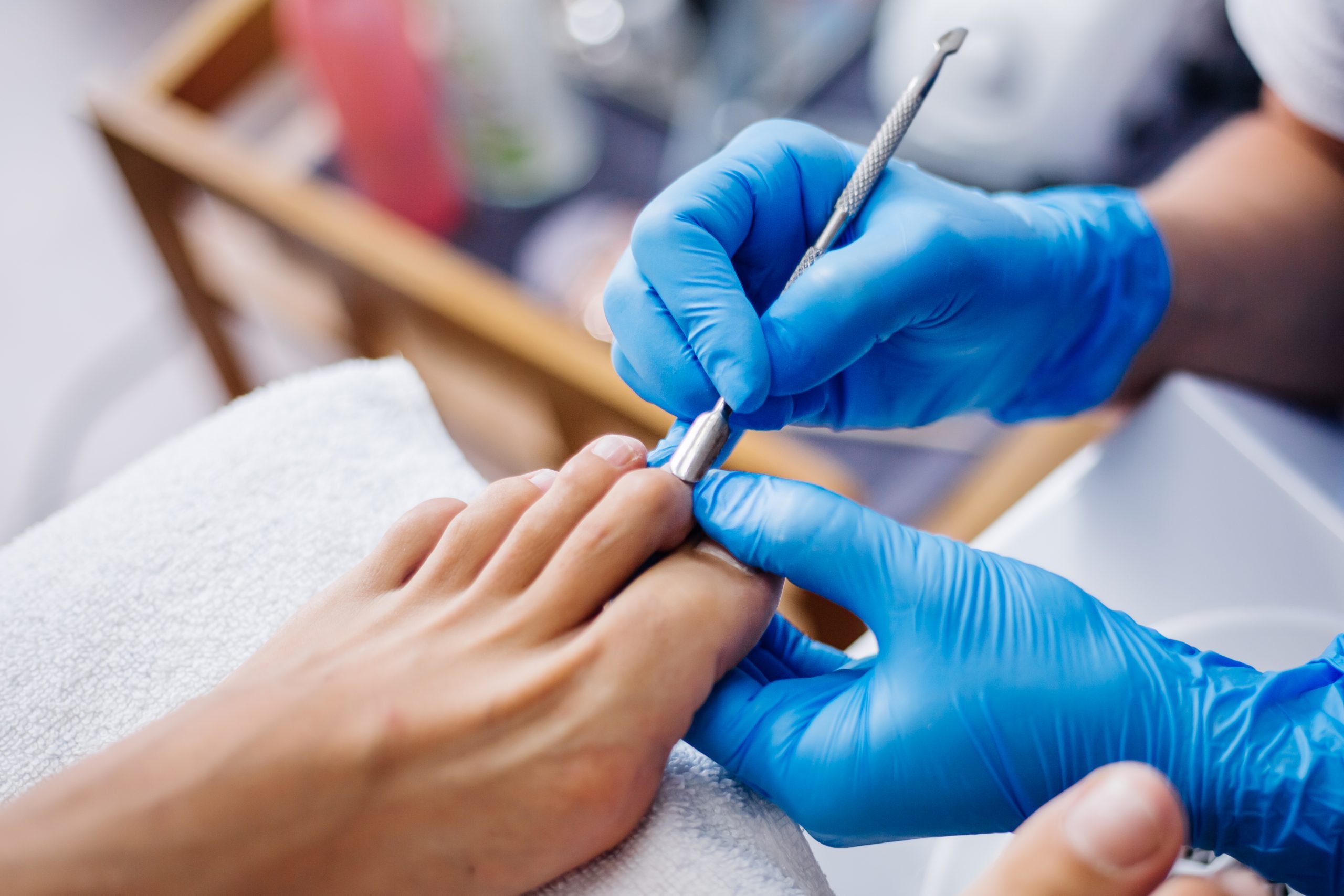 pedicure-process-home-salon-pedicure-foot-care-treatment-nail-process-professional-pedicures-master-blue-gloves-make-pedicure-2